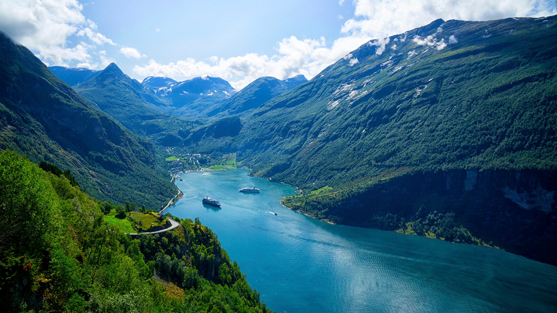 Blue fjord between green mountains